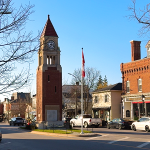 The clock tower is the focal point of the square, surrounded by charming shops and the waving Canadian flag.