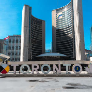 A large building featuring a prominent sign that reads "Toronto" against a clear sky.
